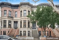 Stunning PLG Limestone Boasting Mantels, Stained Glass, and Bay Windows, Priced at $1.675 Million