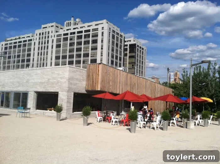 Fornino Pizza Debuts: The Roof Can Wait, The Pizza Can't 2 Fornino Pizza's inviting first-floor dining area at Brooklyn Bridge Park's Pier 6, featuring numerous picnic tables and abundant natural light, promising a delightful culinary experience.