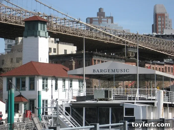 Brooklyn Bridge Park Twilight Symphony Afloat 2 Bargemusic, a unique floating concert hall, moored off Fulton Ferry Slip in Brooklyn Bridge Park, with the iconic Manhattan skyline visible across the East River, prepared for an enchanting classical music performance.