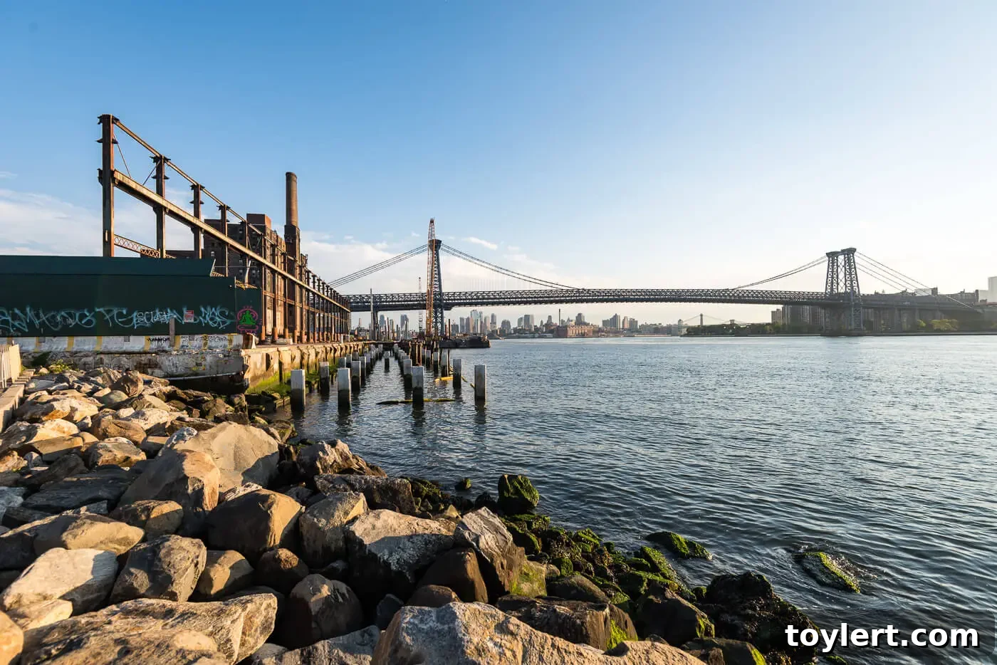 The Domino Sugar site in Brooklyn, with the iconic Williamsburg Bridge providing a dramatic backdrop to the new development.