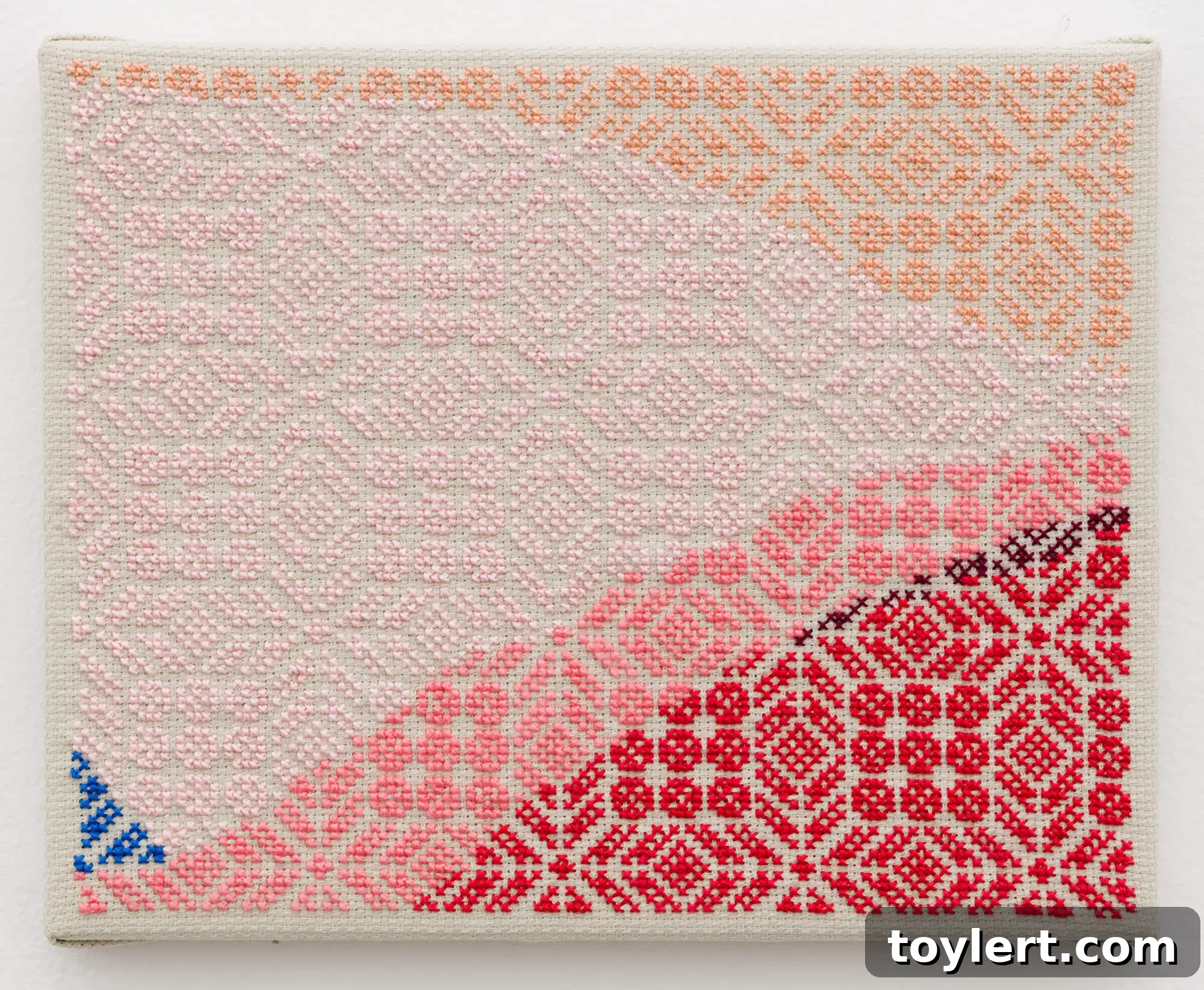 Jordan Nassar's hand-embroidered artwork titled 'Red Which is Blue', a vibrant textile landscape with abstract and traditional elements