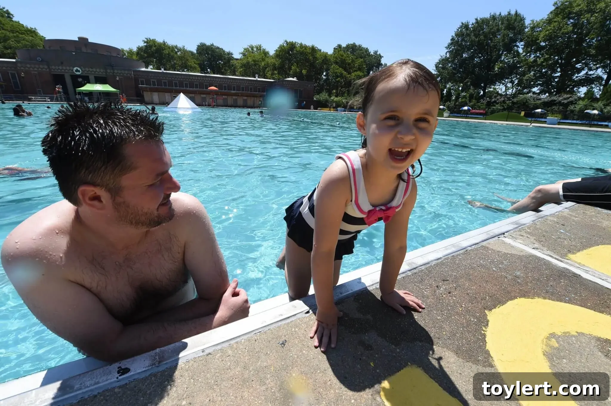 Father and daughter swimming at Sunset Park pool
