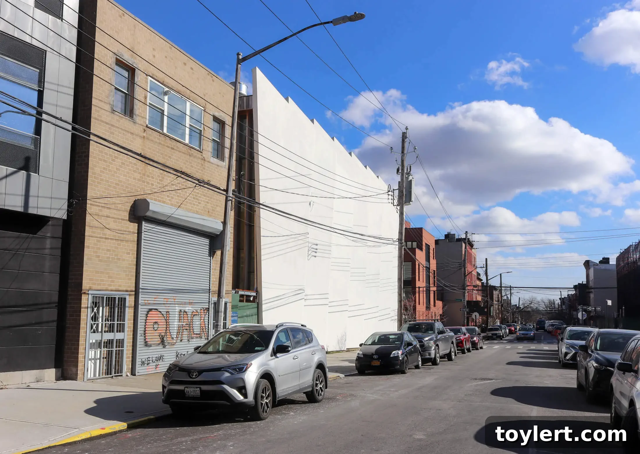 Project Genesis exterior view from Dikeman Street, showcasing the unique architecture of the Red Hook building within the urban landscape.