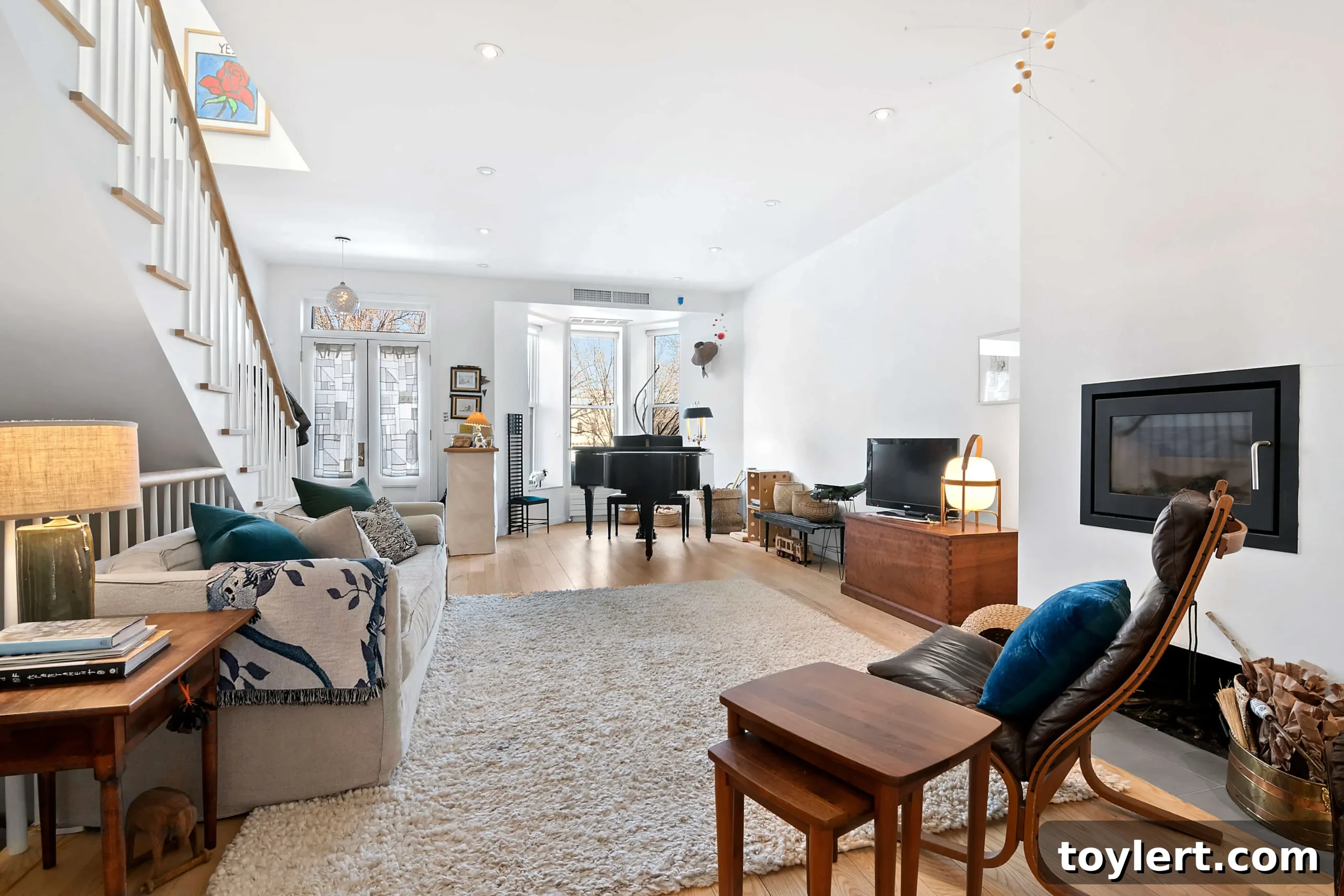 Stunning modern interior of 610 Eastern Parkway in Crown Heights, showing an open living space with contemporary fireplace and kitchen details.