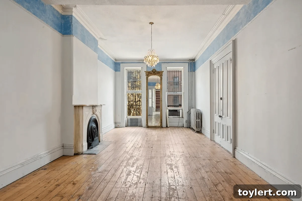 Interior view of an elegant parlor room in a Brooklyn home, showcasing a classic marble mantelpiece, rich hardwood floors, and abundant natural light, indicative of luxury real estate in Park Slope.