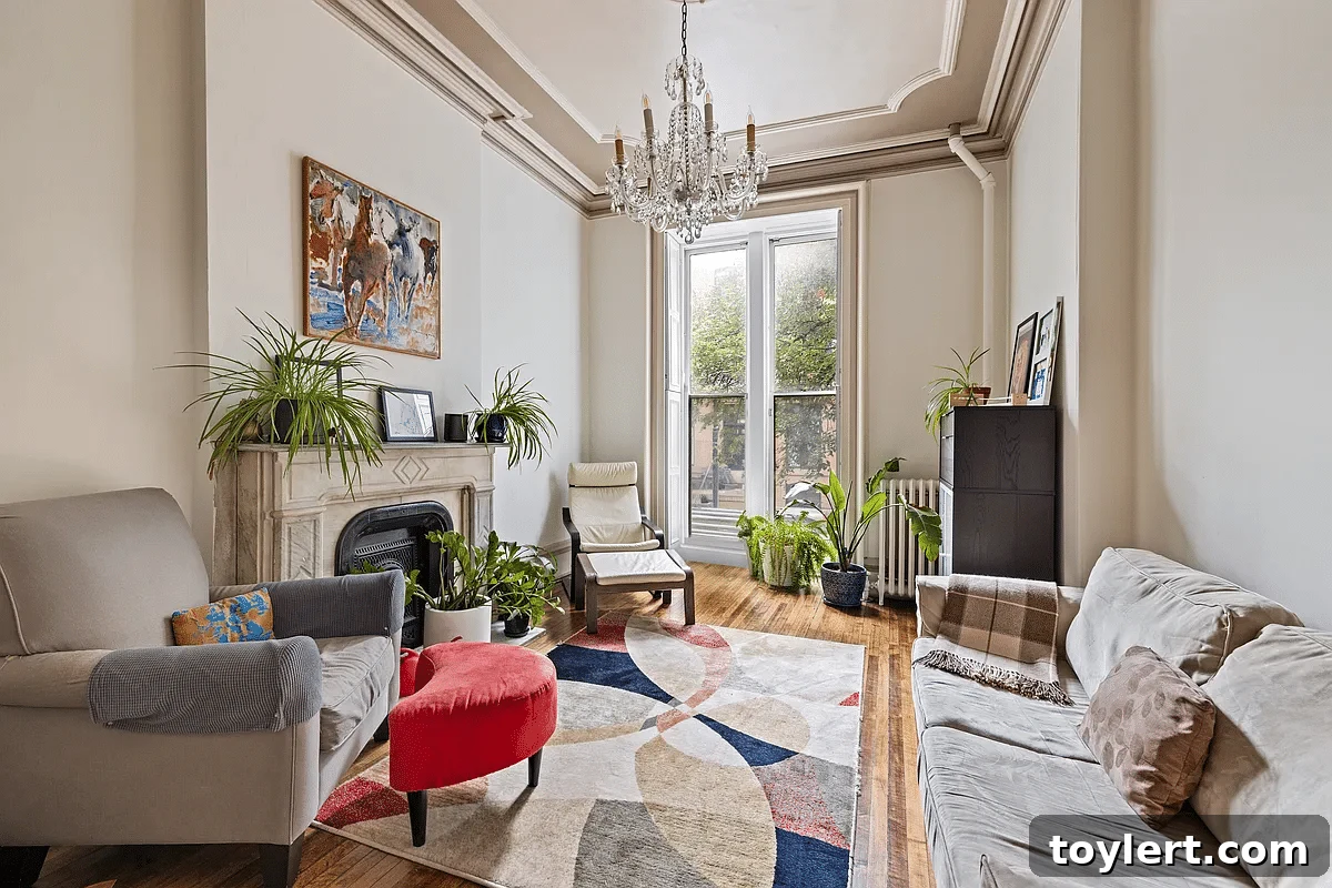 Discover Brooklyn Heights: A Row House and Unseen Potential From $1.999 Million 2 Exquisite parlor with an ornate marble mantelpiece in a historic Brooklyn Heights brownstone.