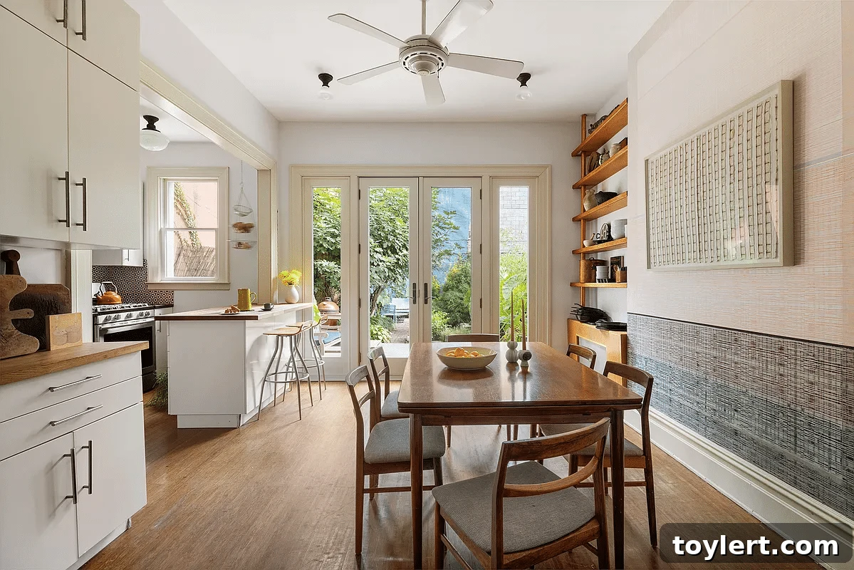 A serene dining room with elegant French doors opening to a lush garden in Carroll Gardens