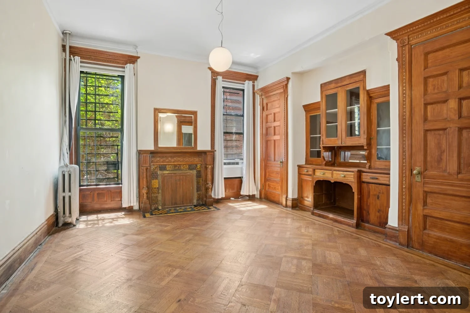 Elegant dining room with a built-in china cabinet and classic details in a Bed Stuy townhouse