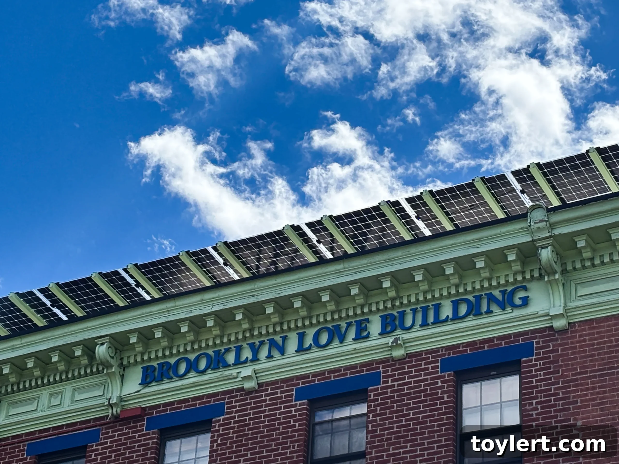 Rooftop Revolution: Solar Power Redefines NYC Homeownership 2 Solar panels installed on a modern residential rooftop in Brooklyn under a clear blue sky, illustrating sustainable urban living.